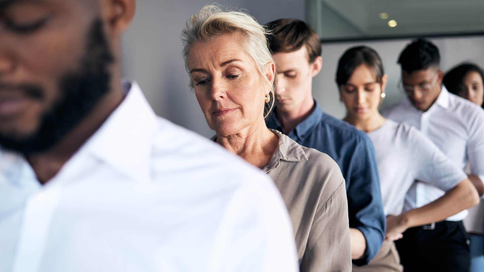 woman stressed out waiting with people in long line