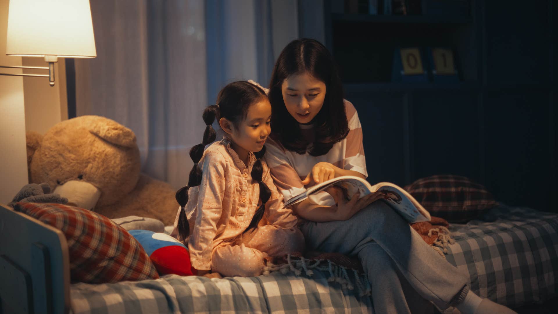 Kindmother read bedtime story to happy daughter showing change forever
