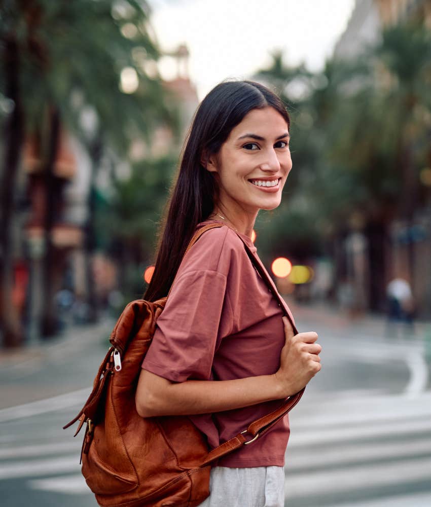 Happy person walks in city showing happier life can't be forced