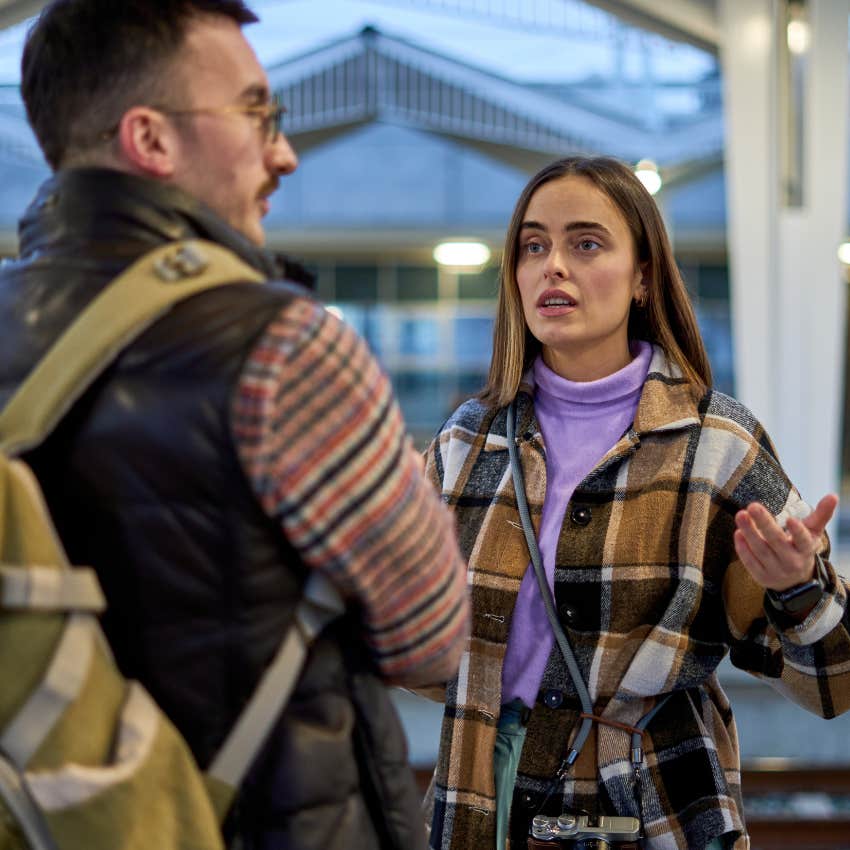 Woman saying "you're overreacting" to her partner in public.