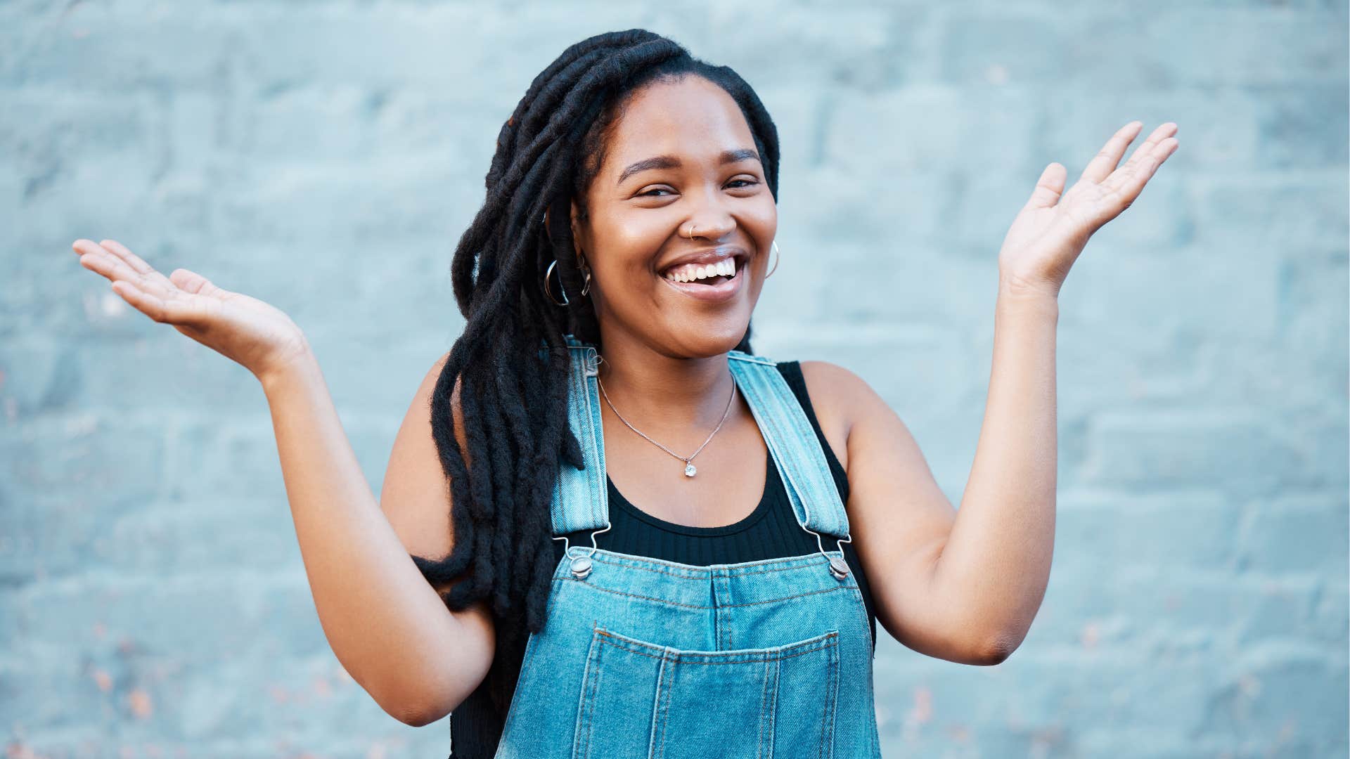 Excited person raises hands and steps out to find good in the world