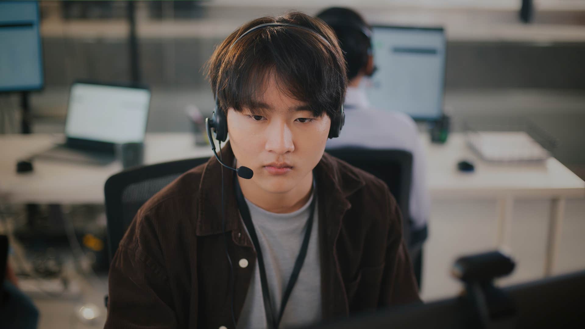 employee sitting at desk with headset on 