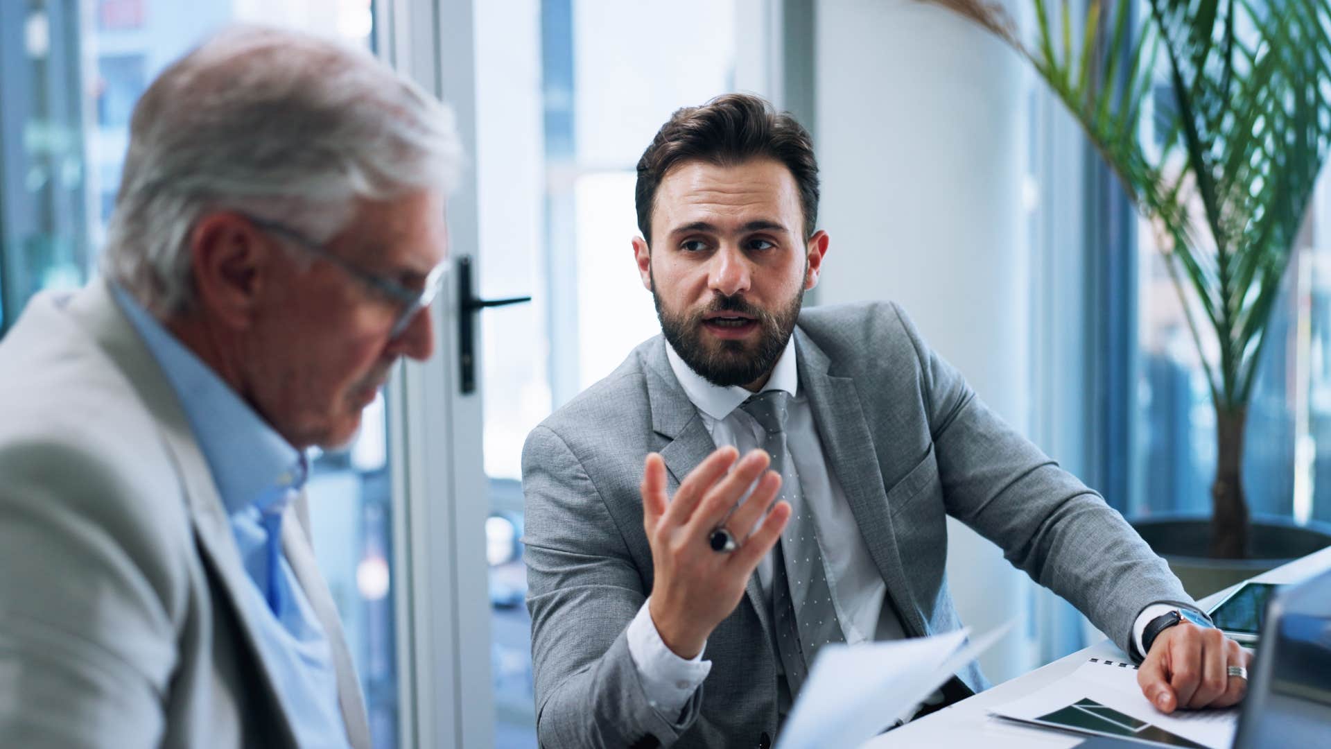 employee talking to boss in office saying let's circle back