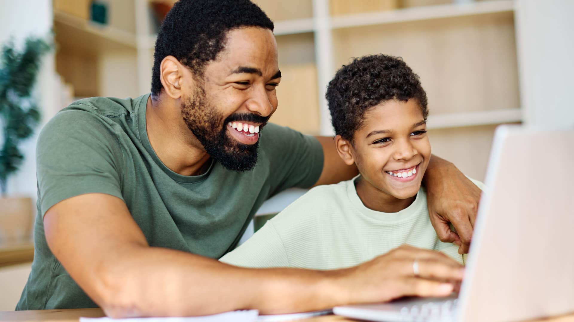dad making son feel proud after using laptop