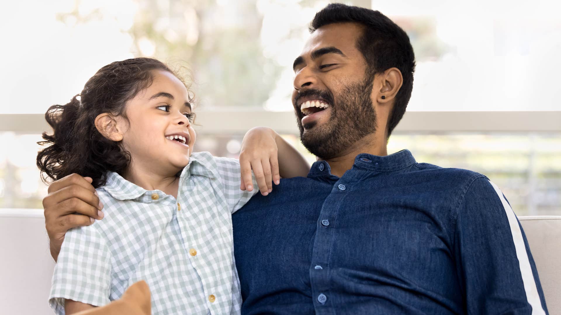 dad making daughter laugh in stressful moment