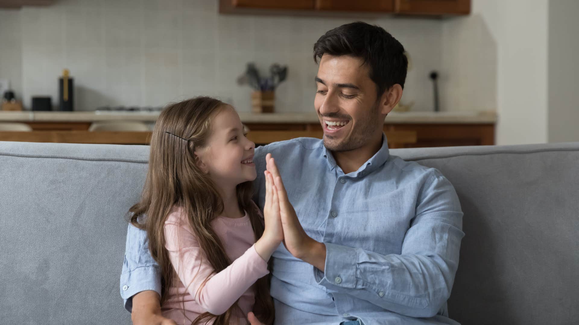 dad giving daughter high five