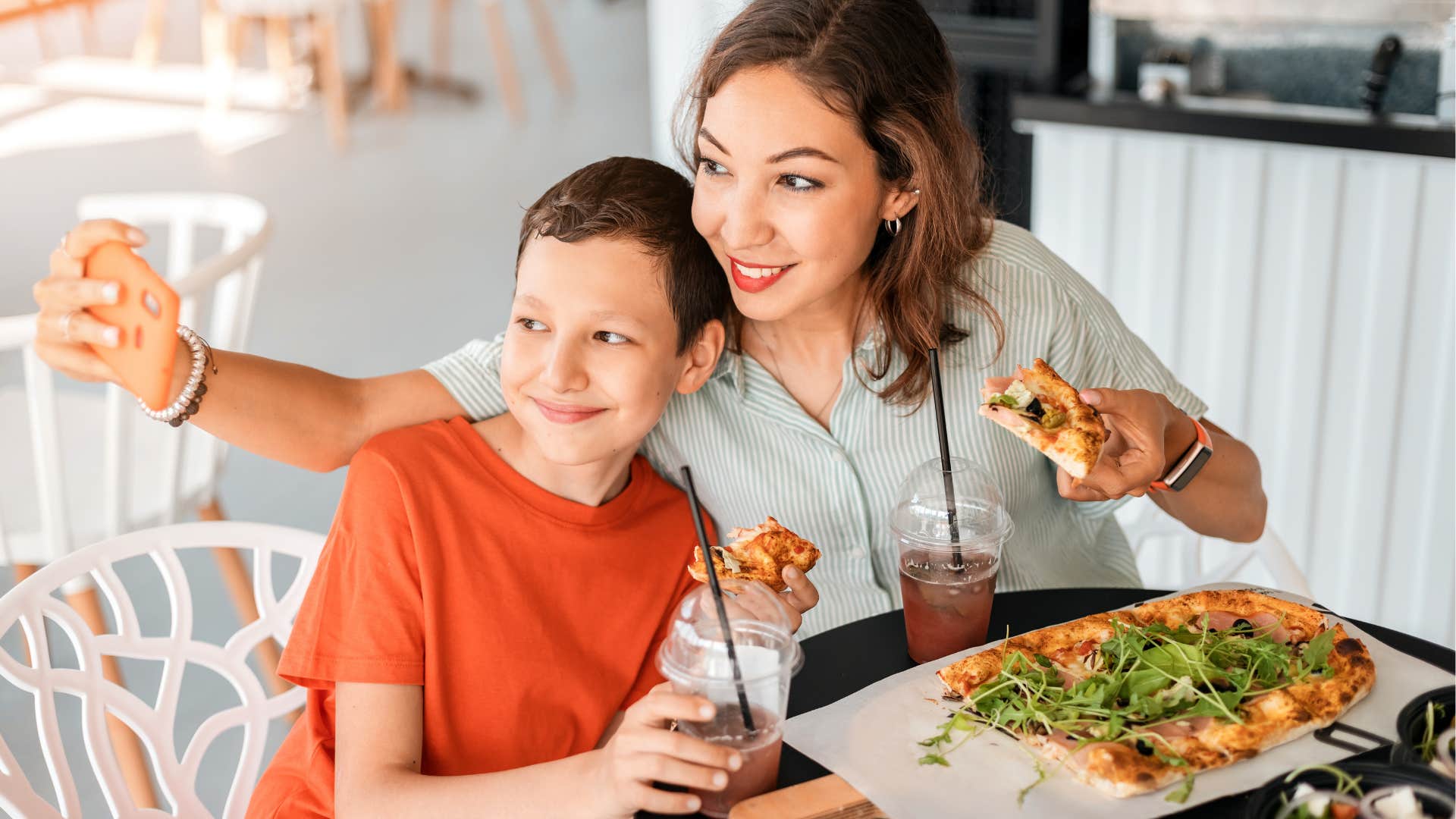 Smiling parent and child sharing meal out showing way kids feel seen