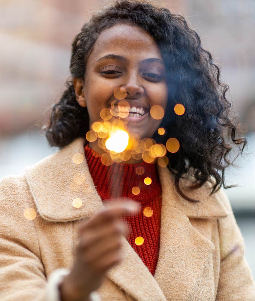Happy person with sparkler showing way to save self to find someone