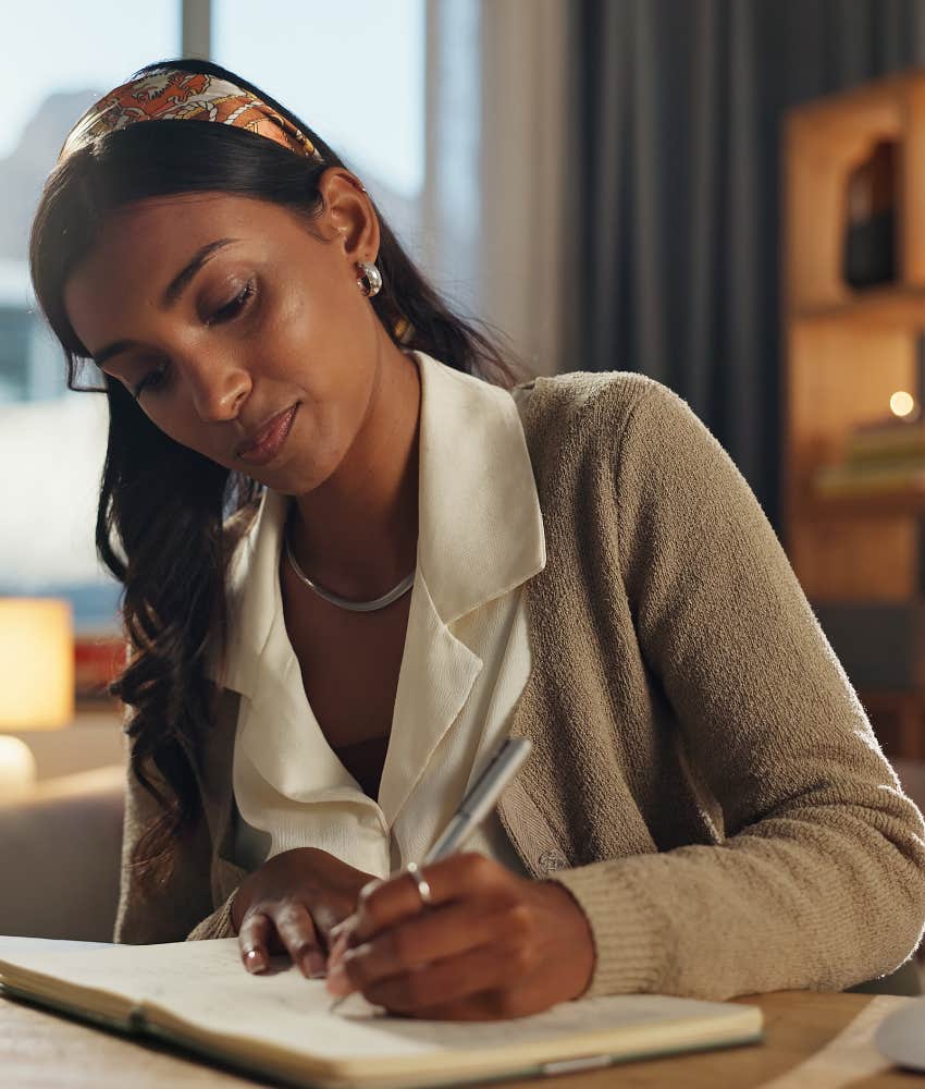 Focused person writes out plan showing change to feel good