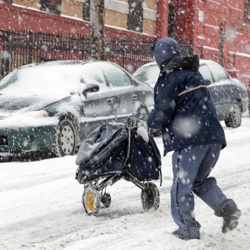 mail carrier delivering mail in snow