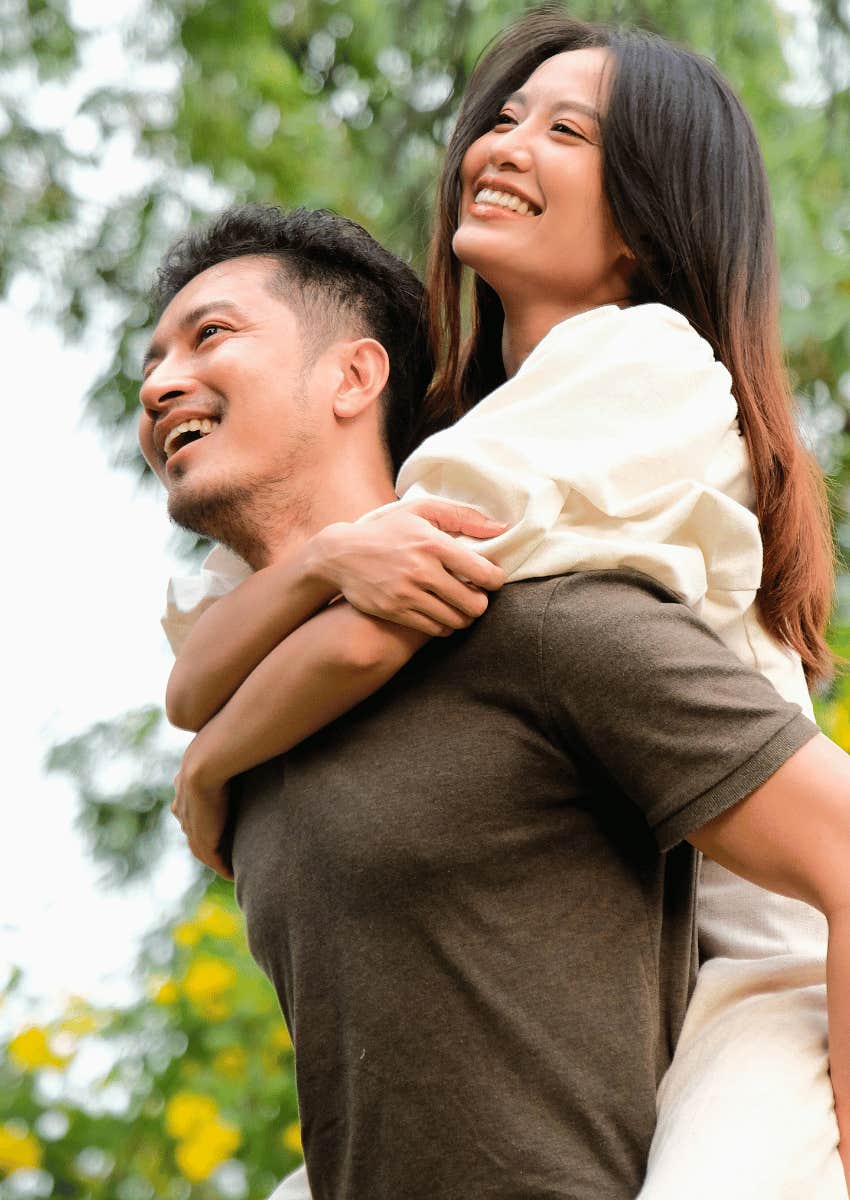man carrying woman on his back