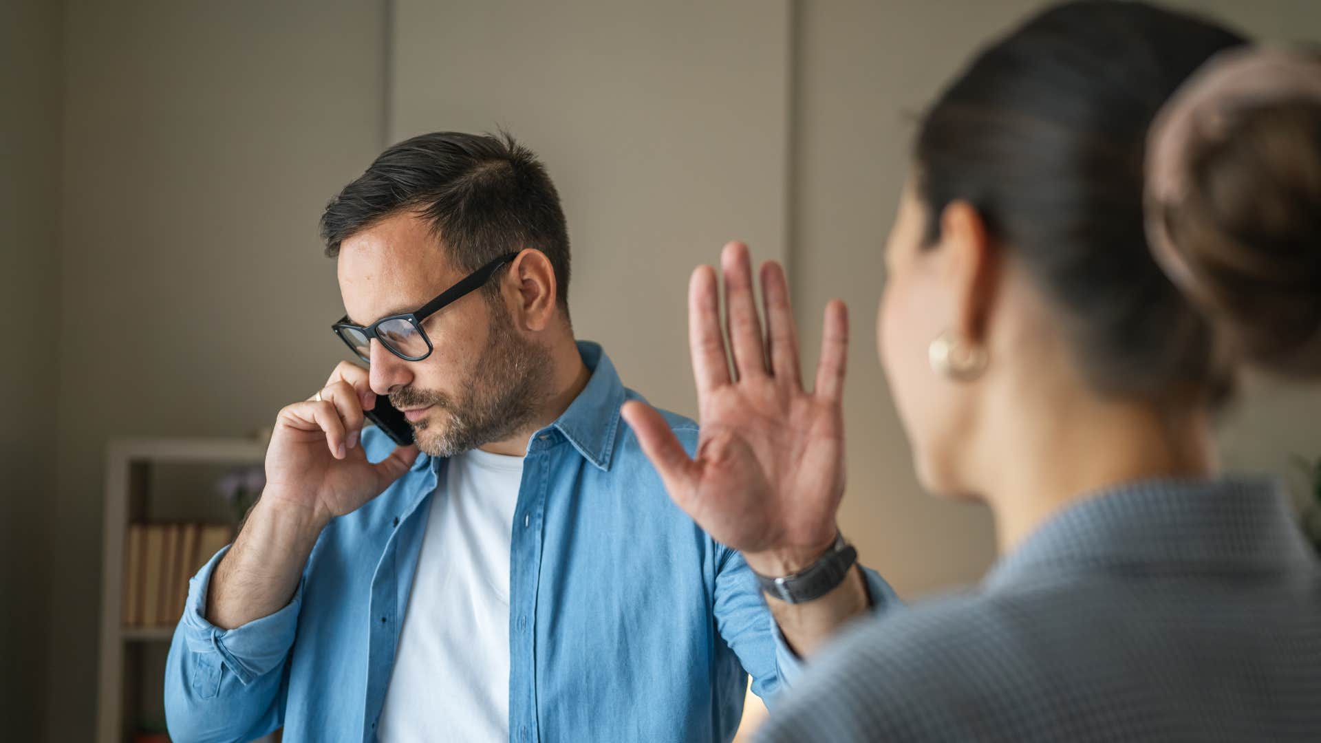 Lying man pon phone hold up hand showing sad behavior