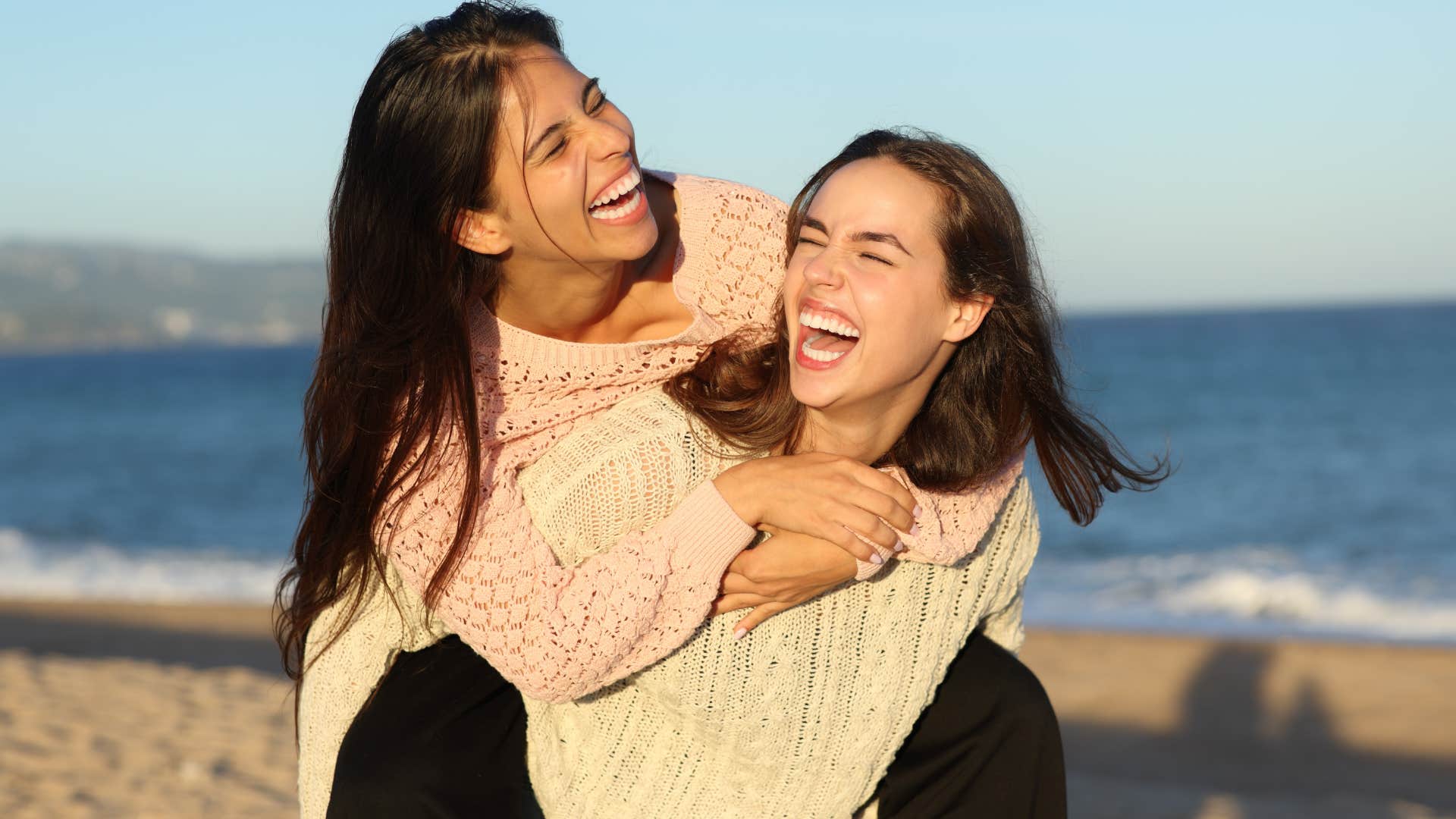 teenage girls smiling on an annual vacation at the beach