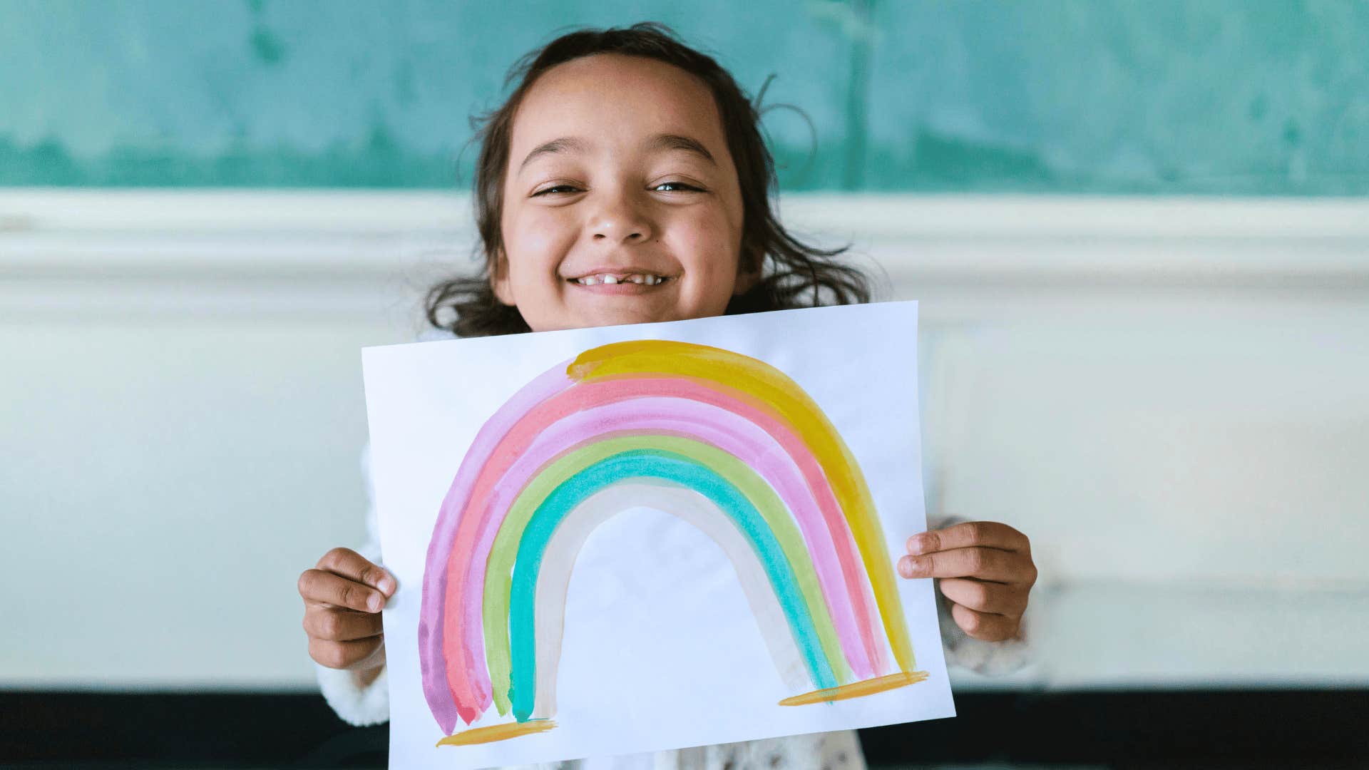 modern parent showing kids art for fridge display