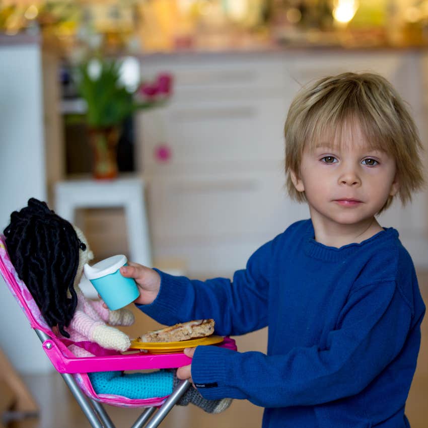 little boy feeding baby doll mom teaching do chores tend kids
