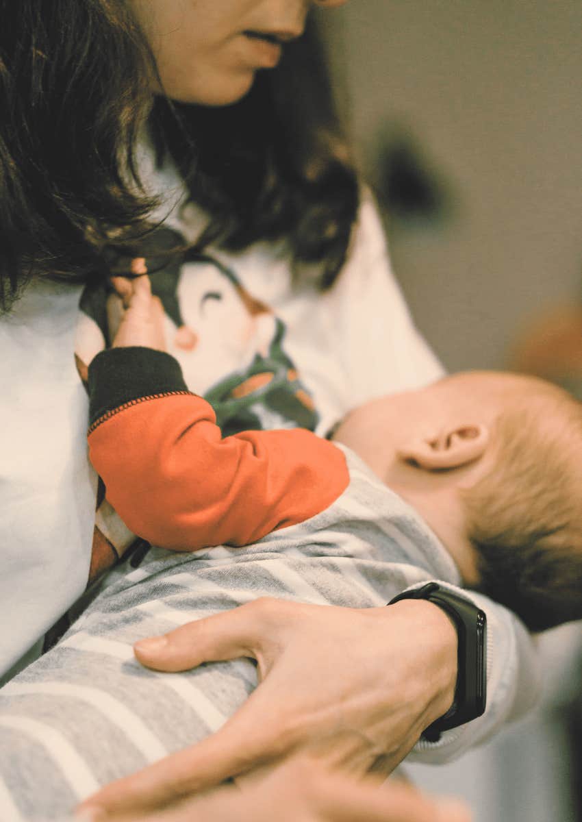 mother holding infant close to chest