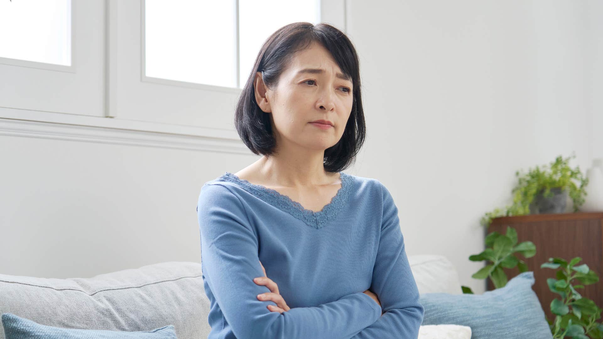 annoyed woman sitting with arms crossed