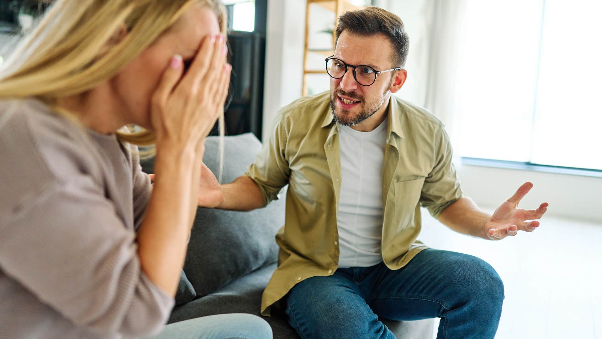 man getting defensive in conversation with partner