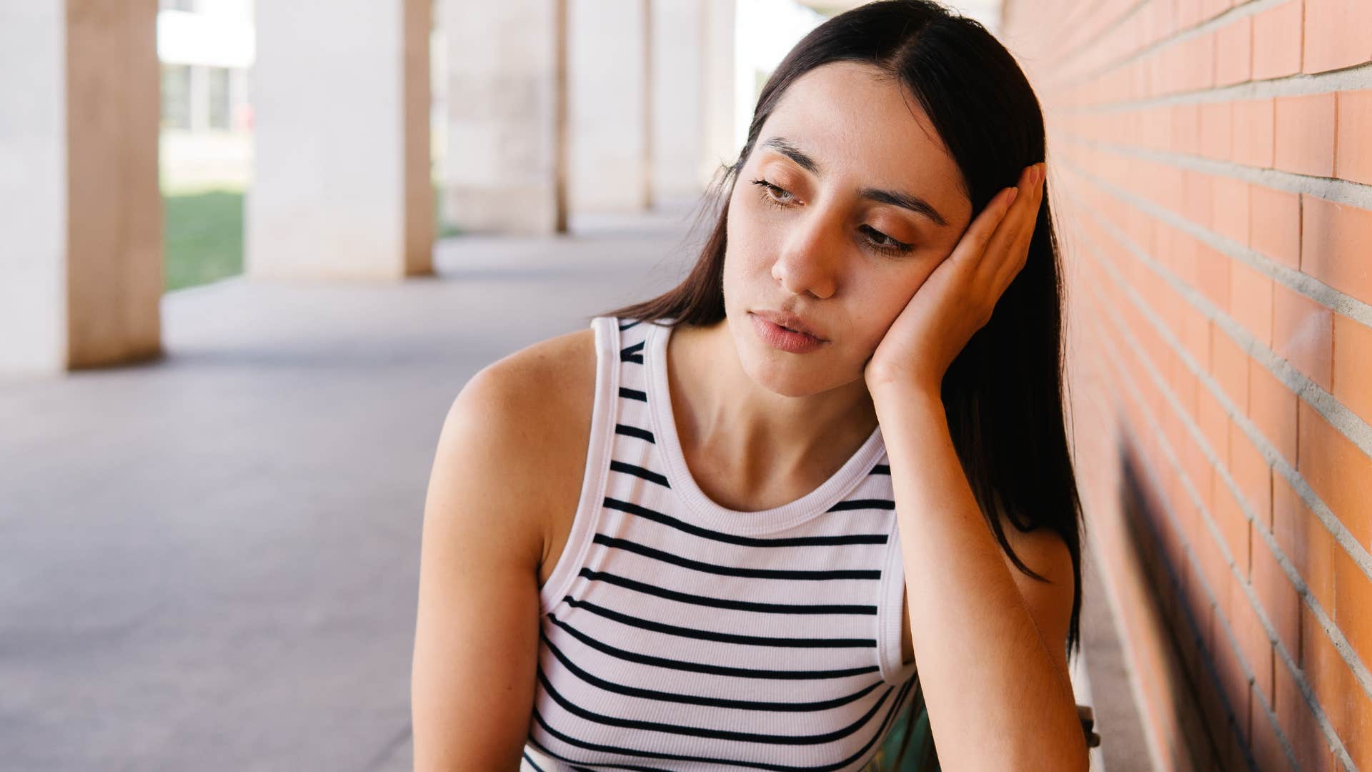 woman who lacks resilience looking upset outside