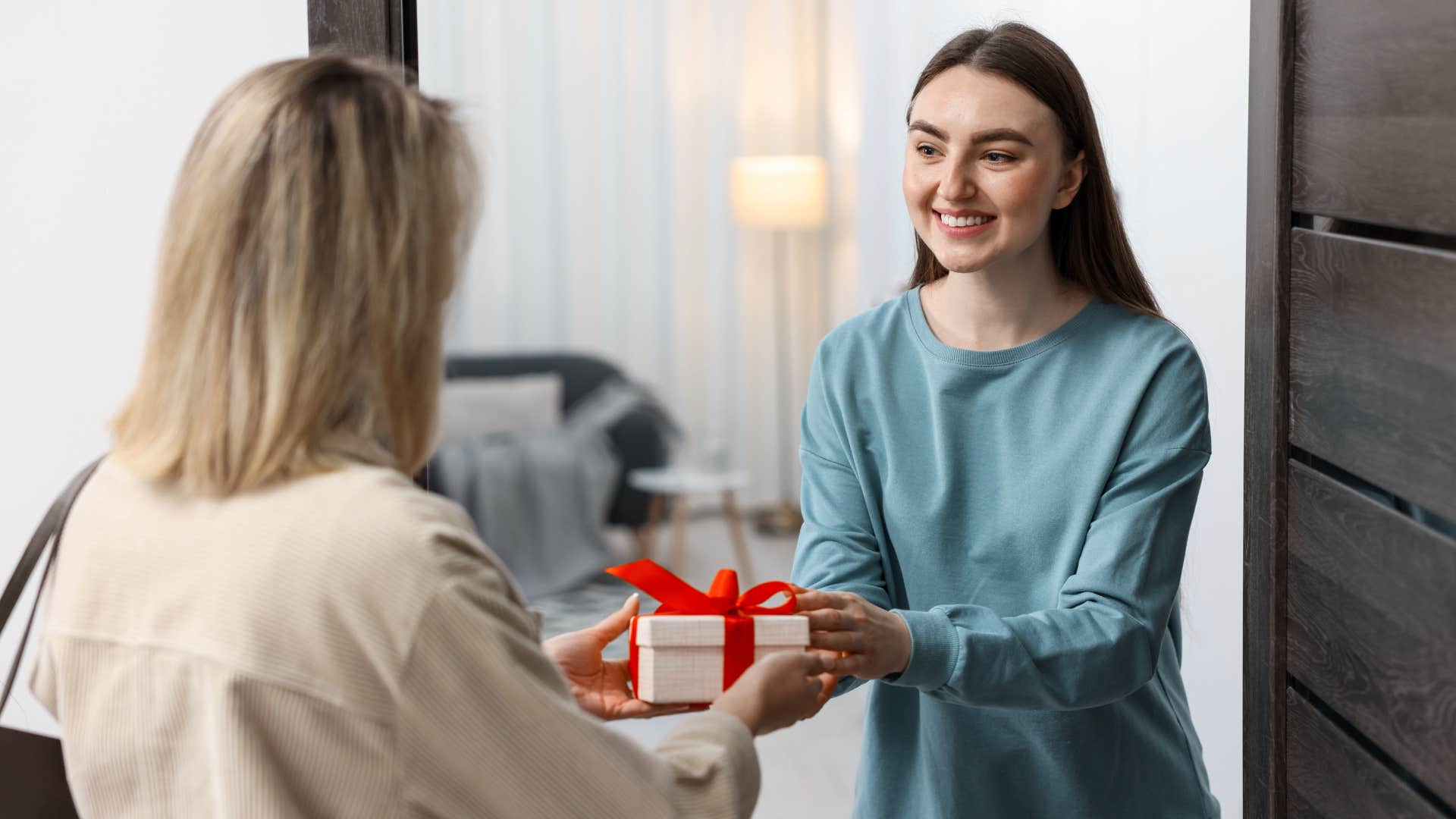 woman giving gift to friend to avoid being a burden