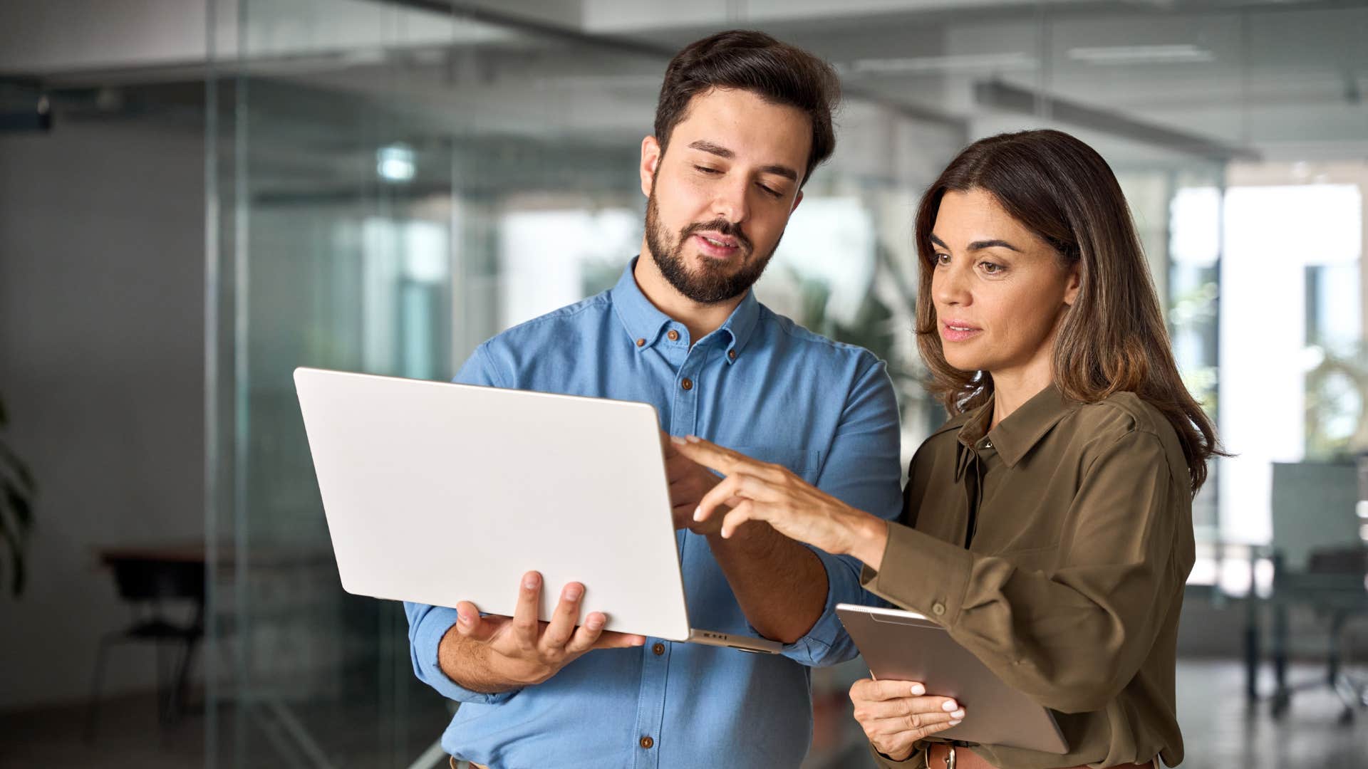 woman pointing at laptop as she says let's revisit the original goal