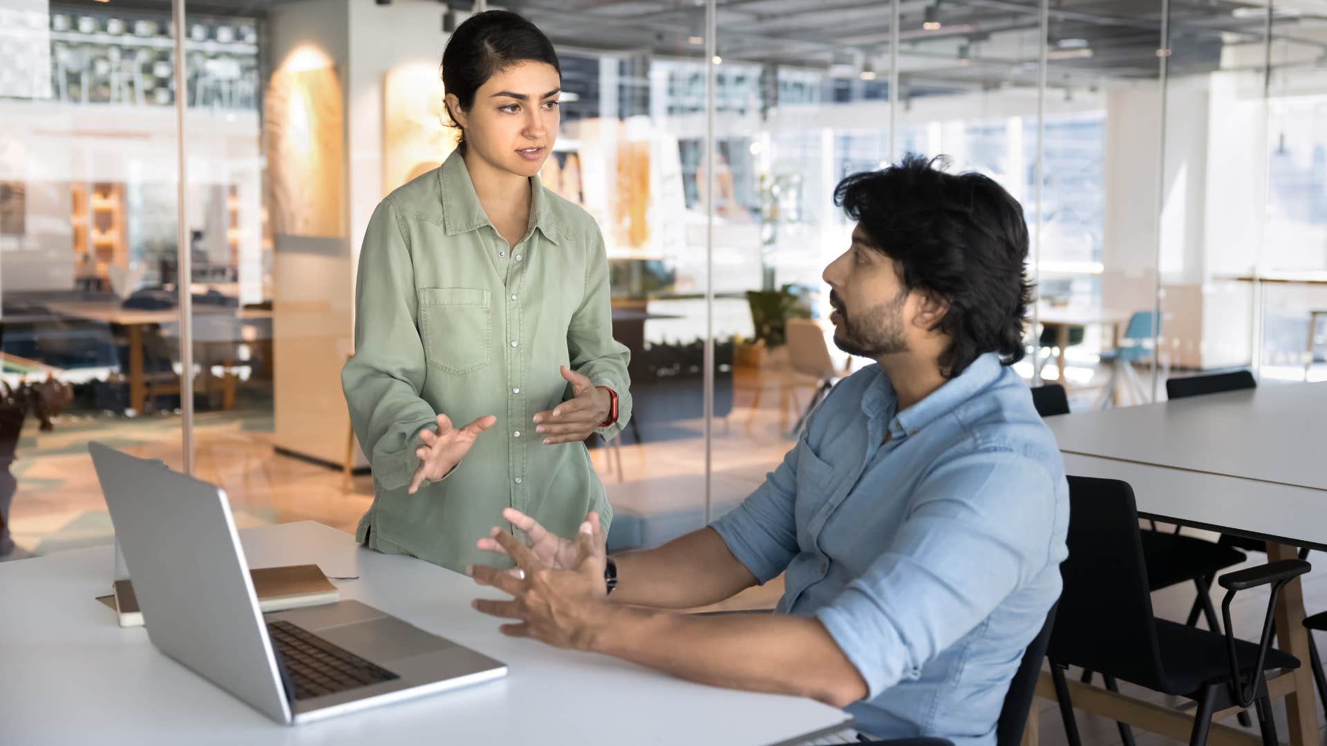 man in blue telling woman oh did you need to jump in here or can it wait