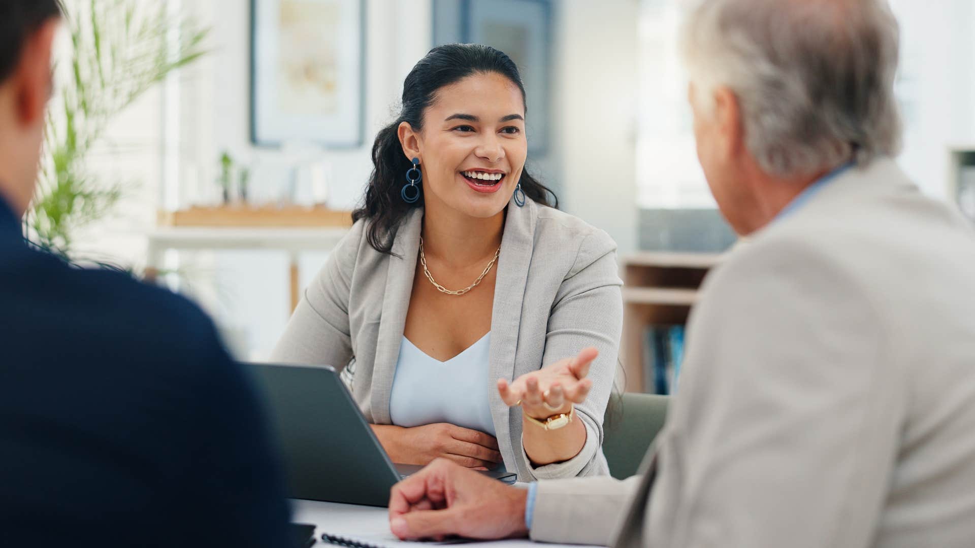 woman telling coworkers what decision are we trying to make in this meeting today