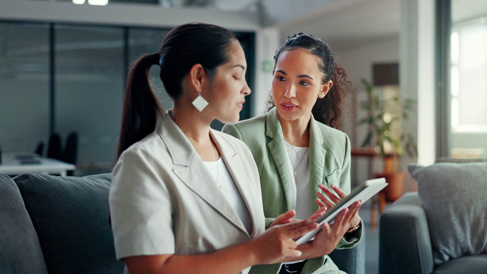 woman talking to coworker as she asks what's driving the timeline on this