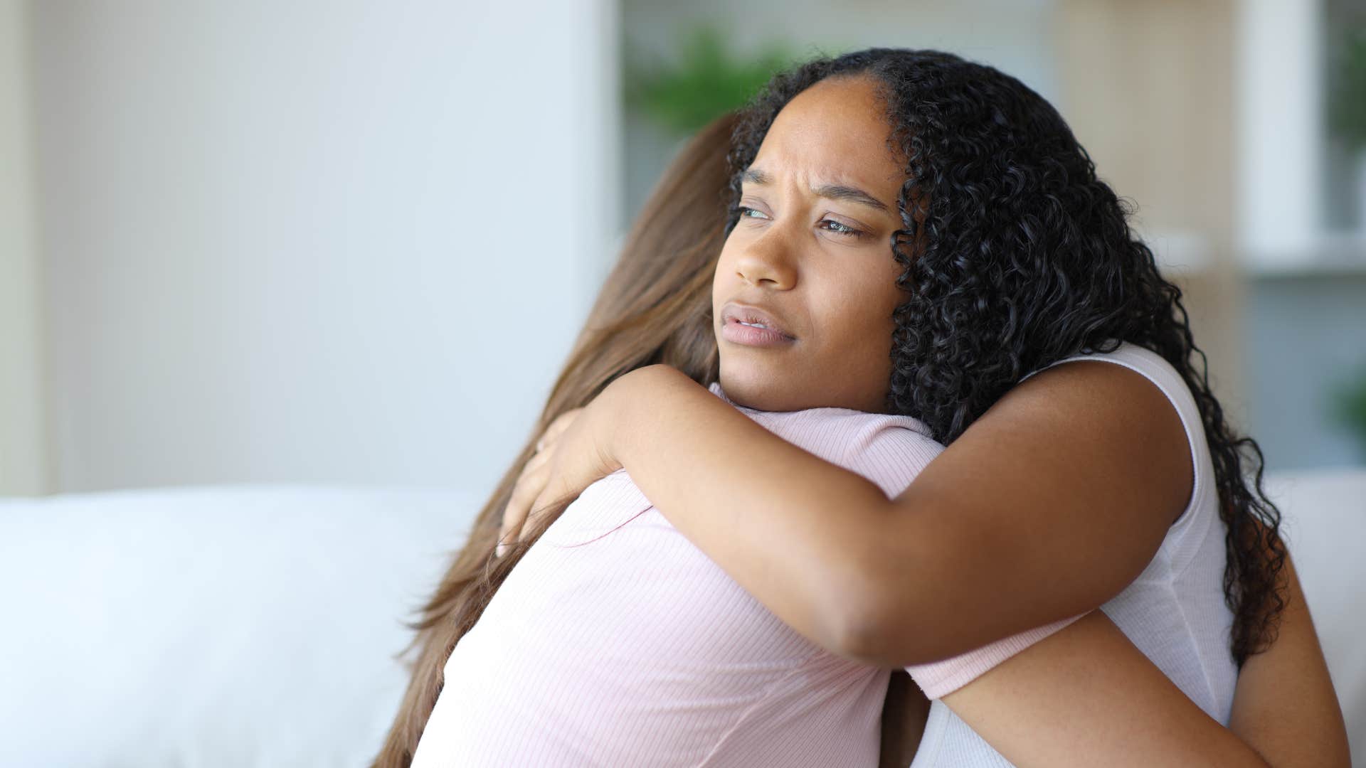 woman hugging friend she doesnt trust passively
