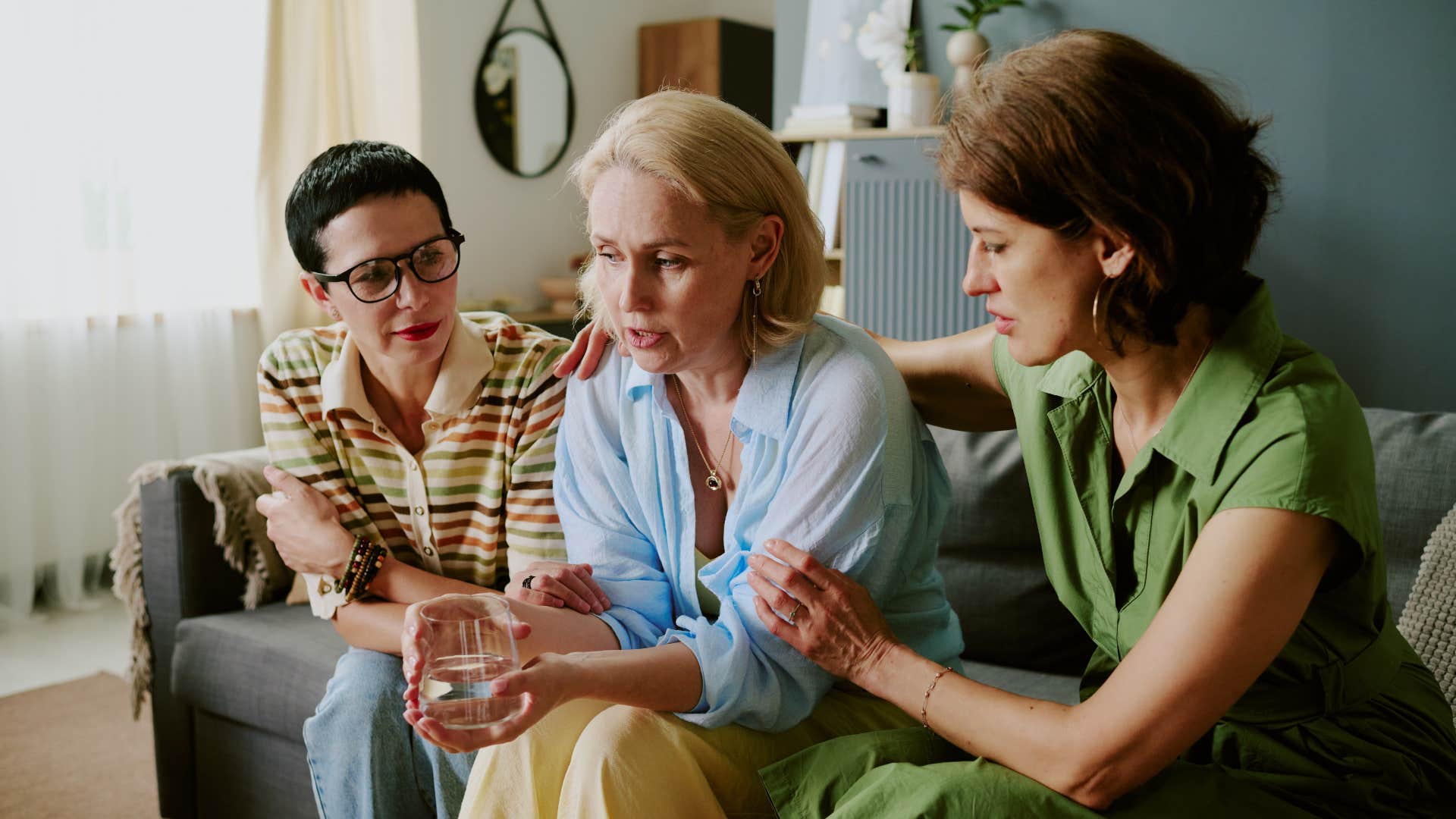 compassionate women comforting friend