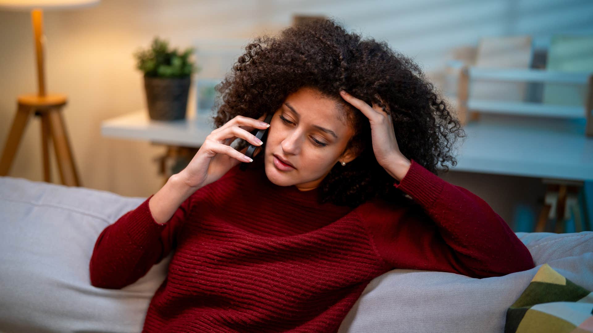 woman in red sweater saying i've been trying to protect my peace on phone