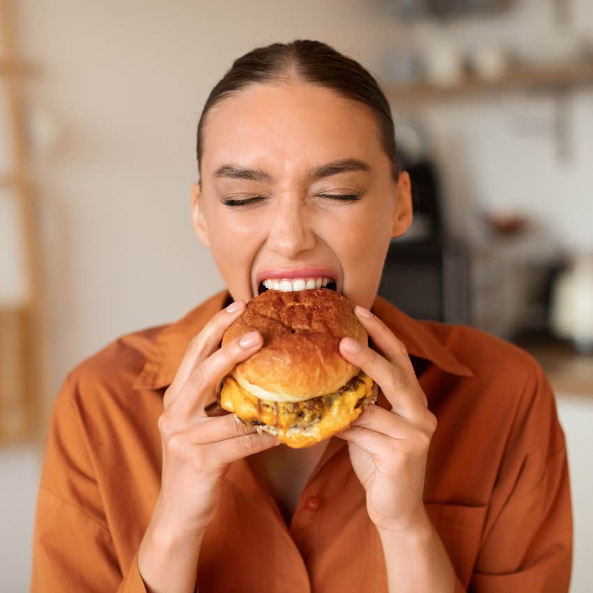 woman enjoying a burger more likely to live hundred