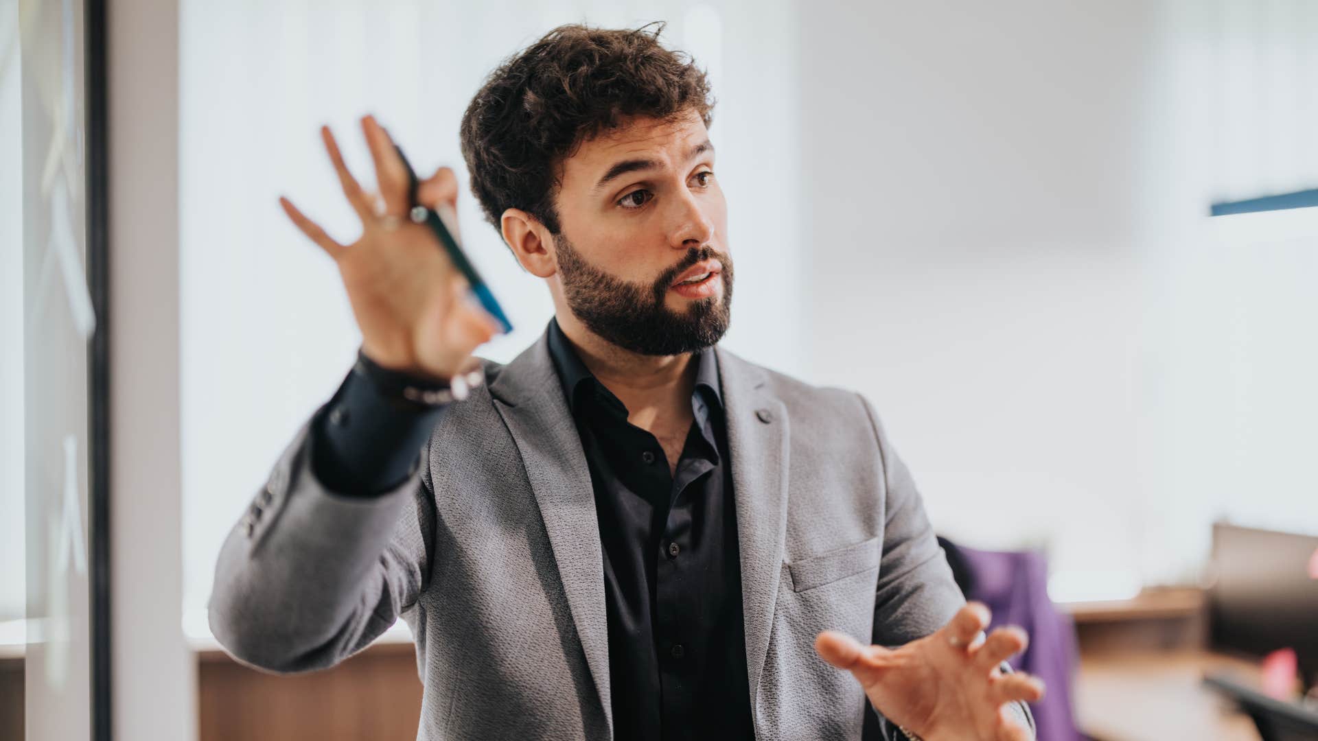 man in dark shirt engaging in endless hypotheticals 