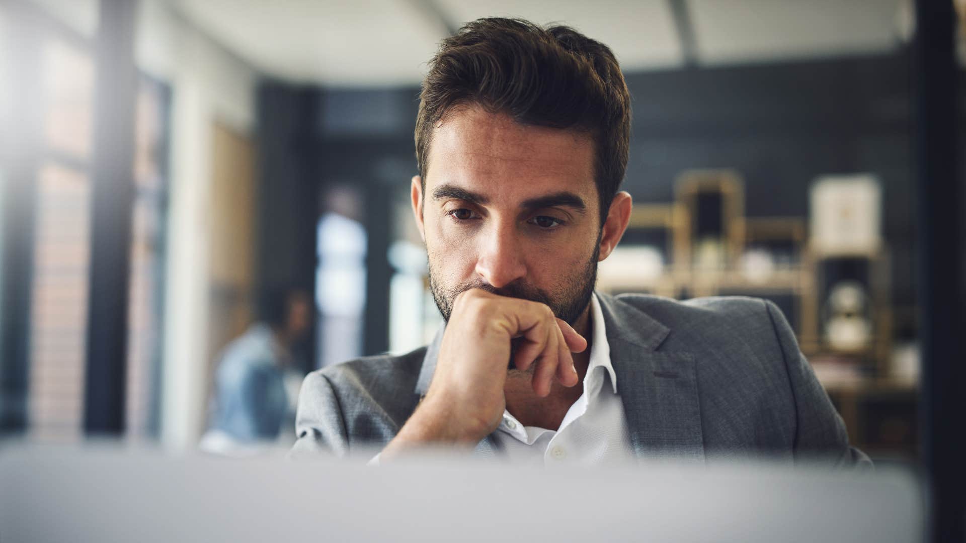man looking at laptop being a deep thinker