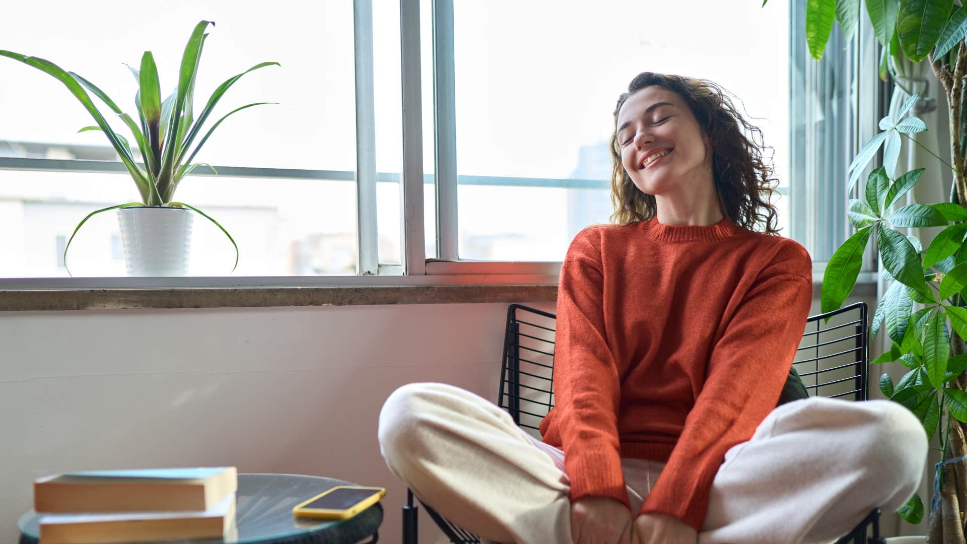 woman in red emotionally grounded as she smiles