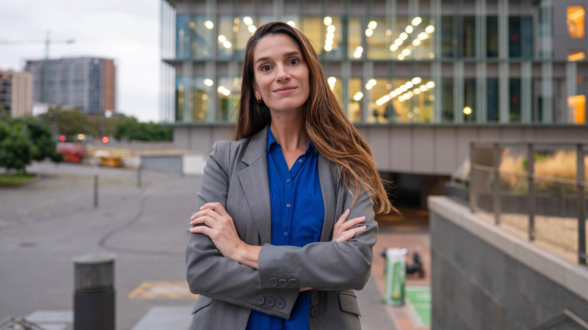 woman in gray jacket crossing arms as she's overprotective