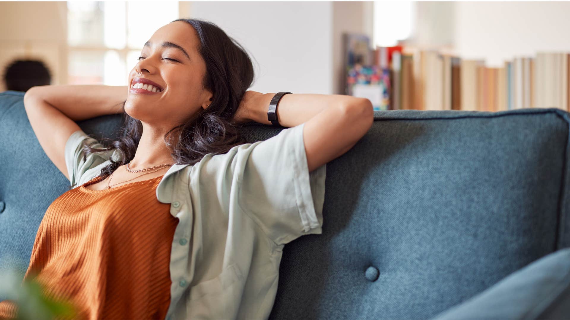 woman relaxing on couch as she values predictability