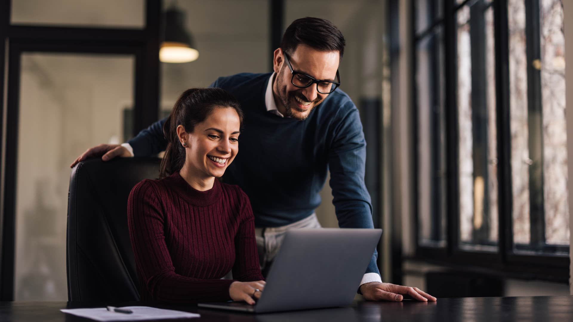 man and woman working on laptop as one person asks Can you show me how you did this