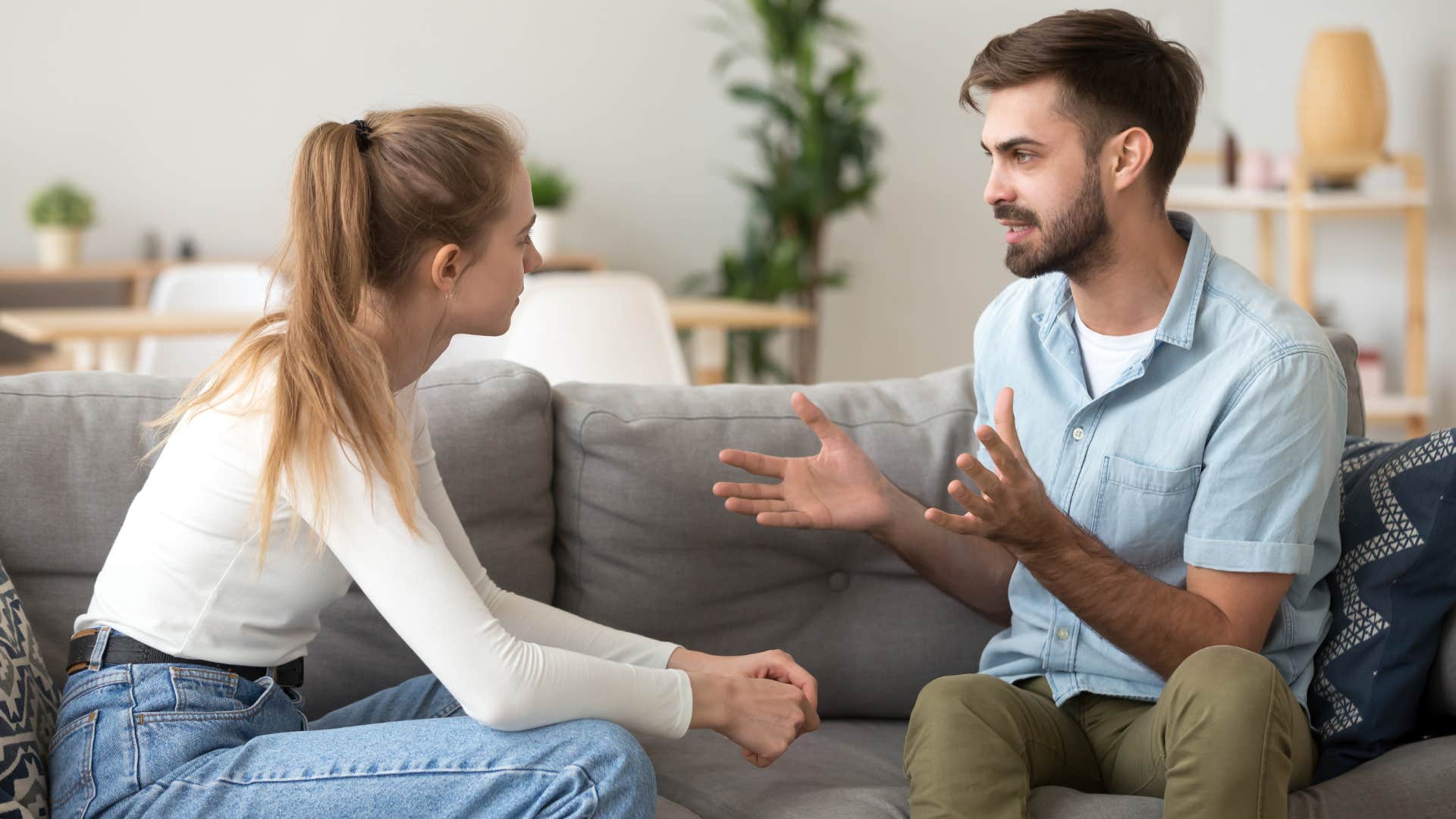woman in white shirt listening to man as he answers the question What helped you get through that
