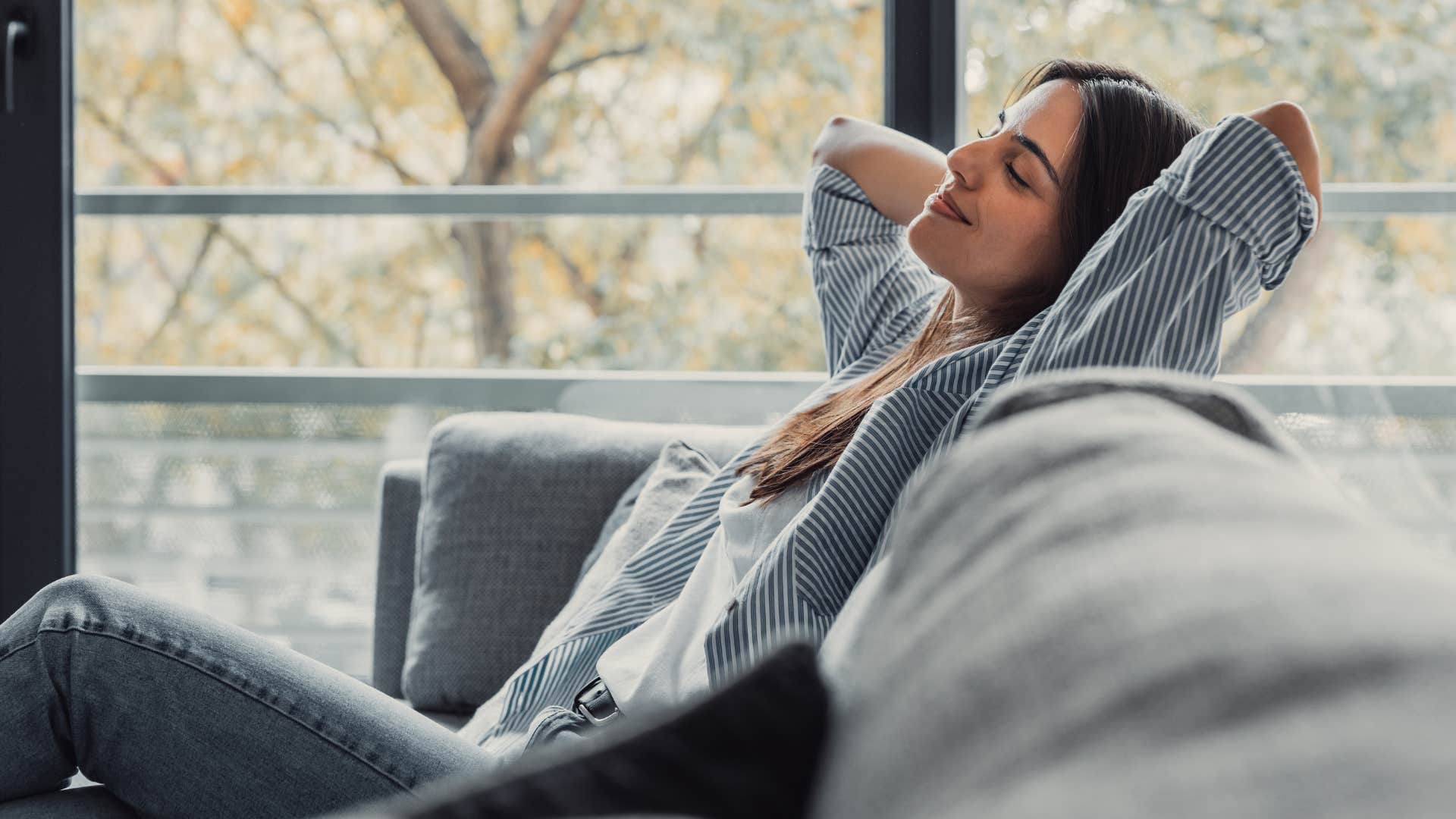woman relaxing on the couch as she's a selective energy spender