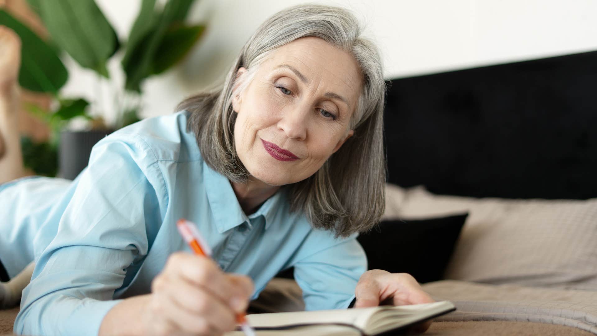 Aware person writes in notebook showing thins to rebuild life