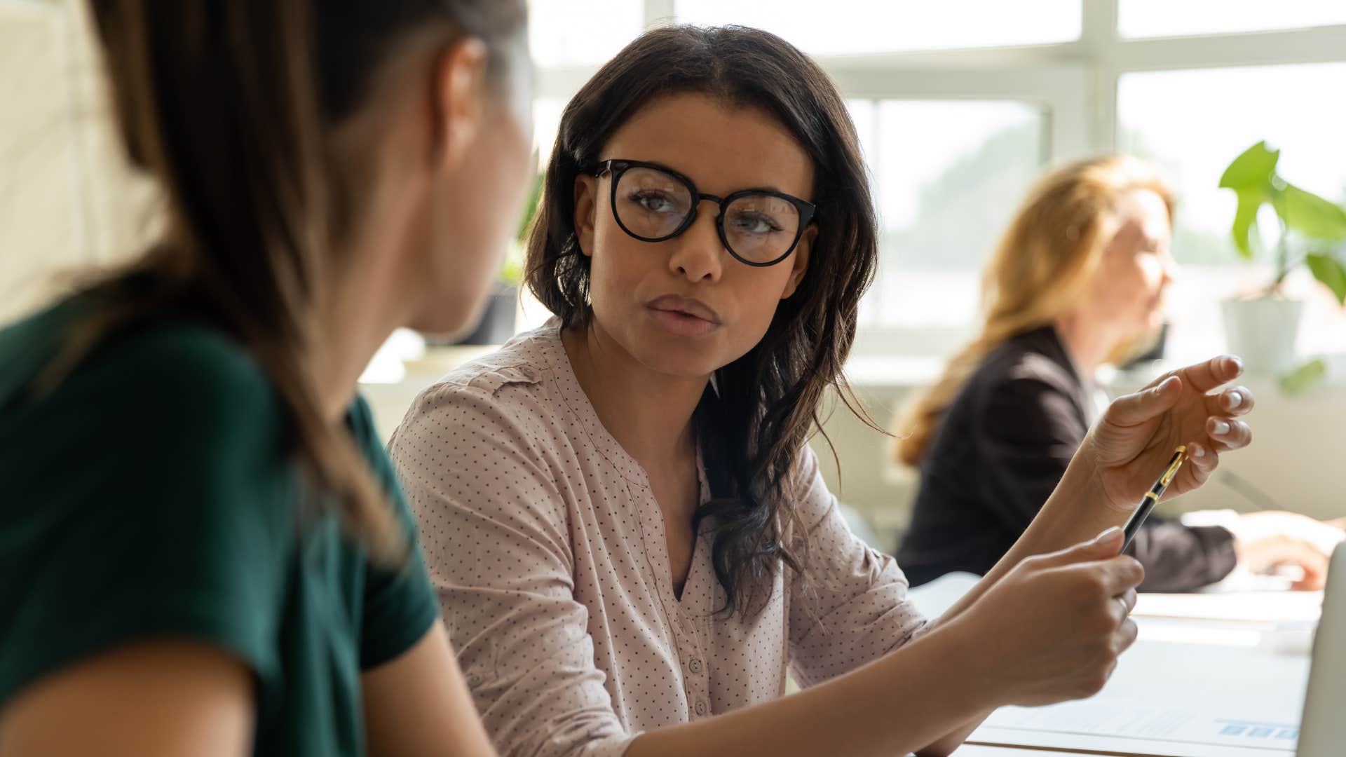 Professional person talks to mentee showing thing to rebuild life