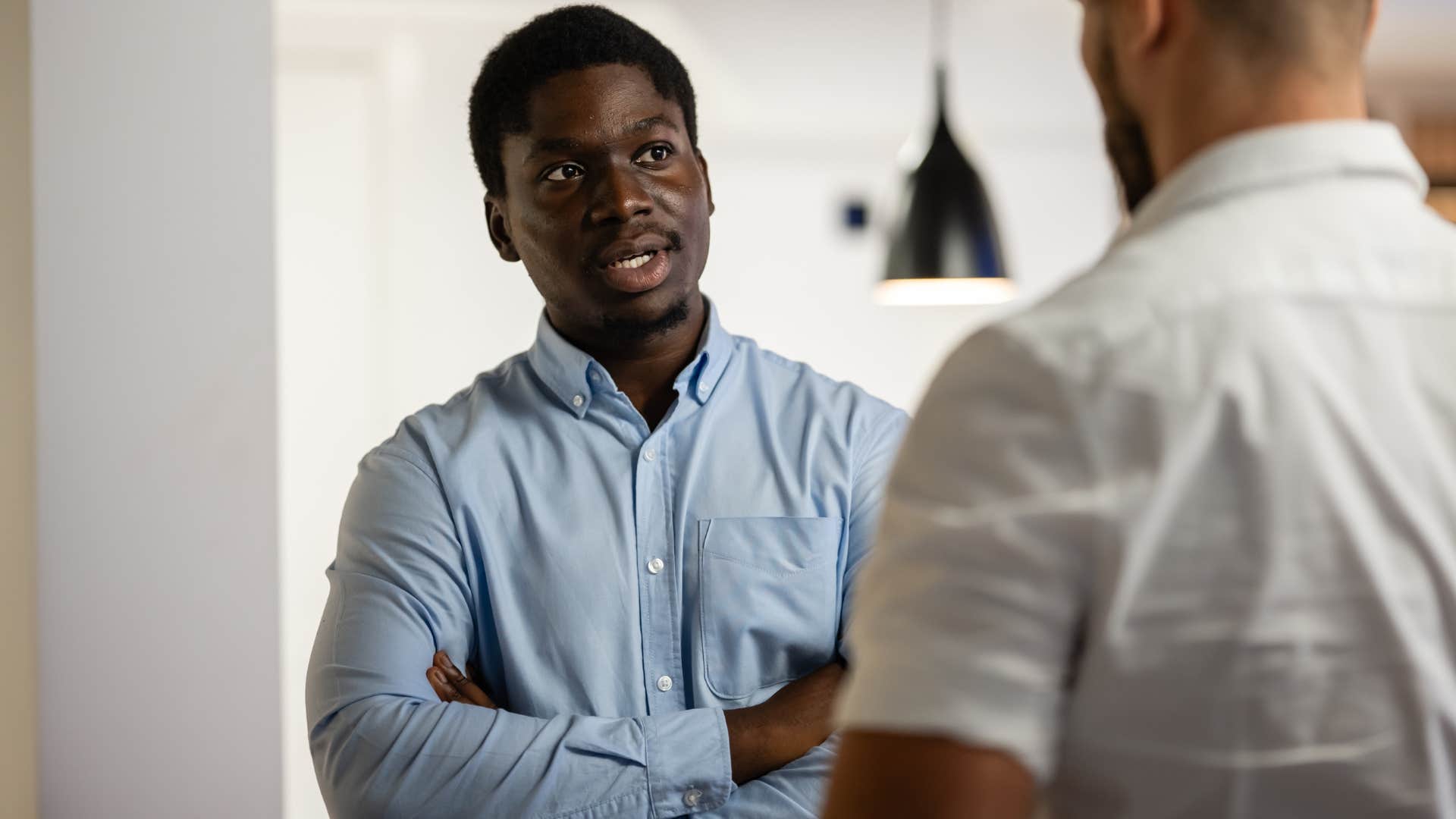 man saying anyway to a friend in conversation