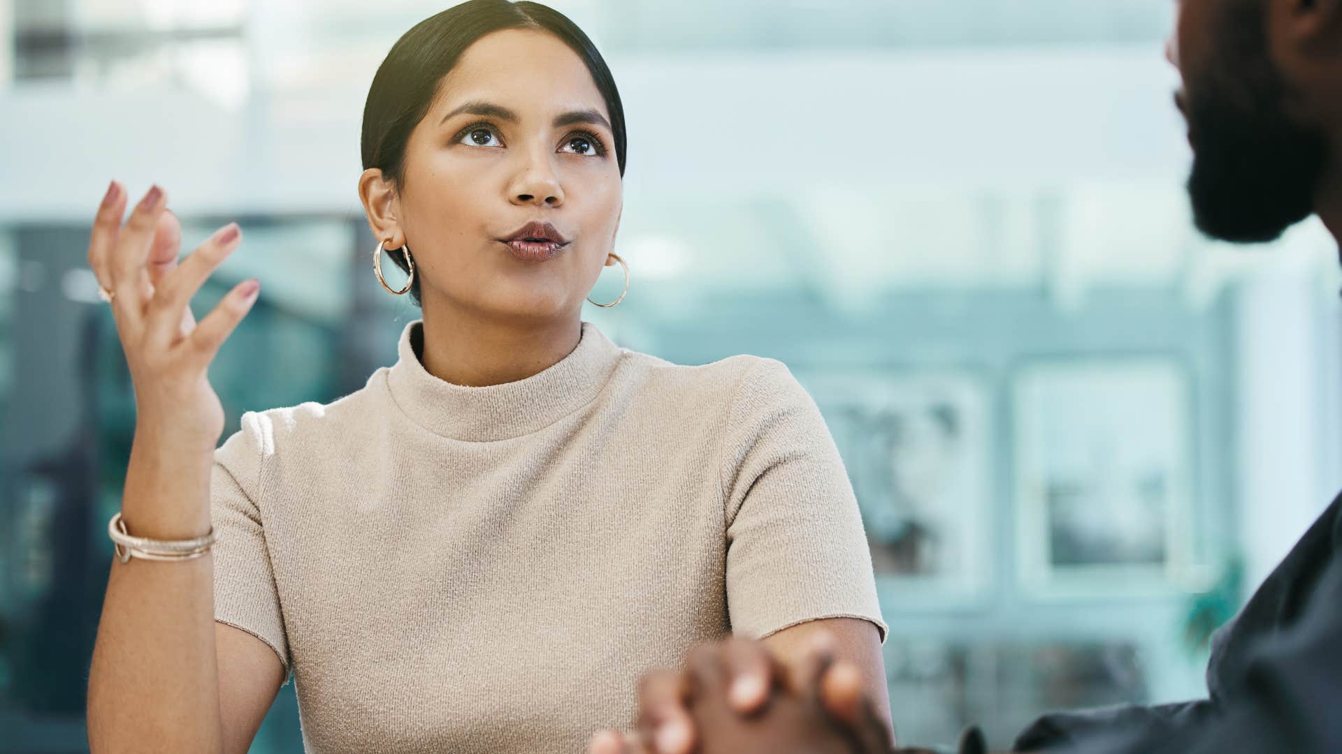 annoying woman telling colleague that's how the world works