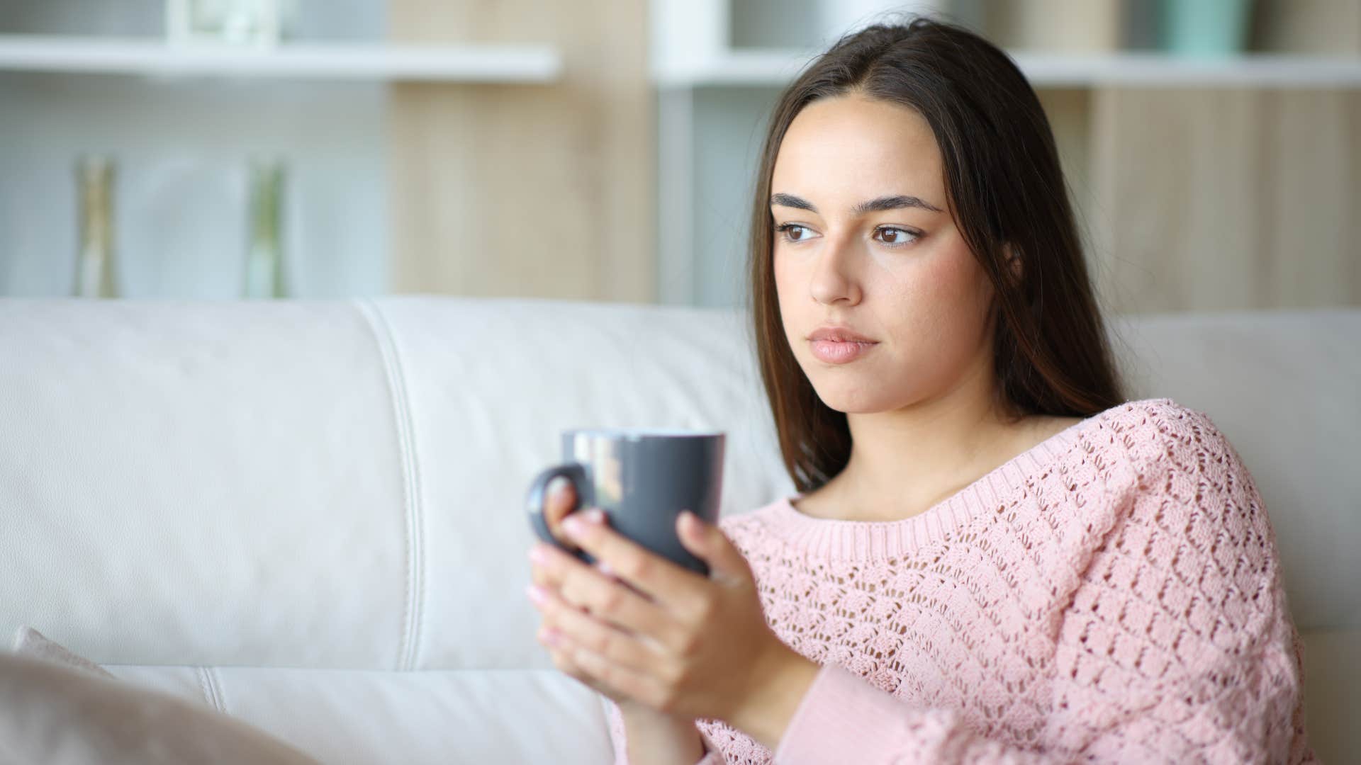 serious woman holding mug