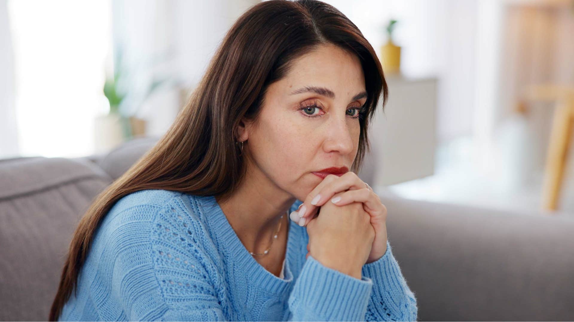 Woman saying "I just try to get through the day" at home.