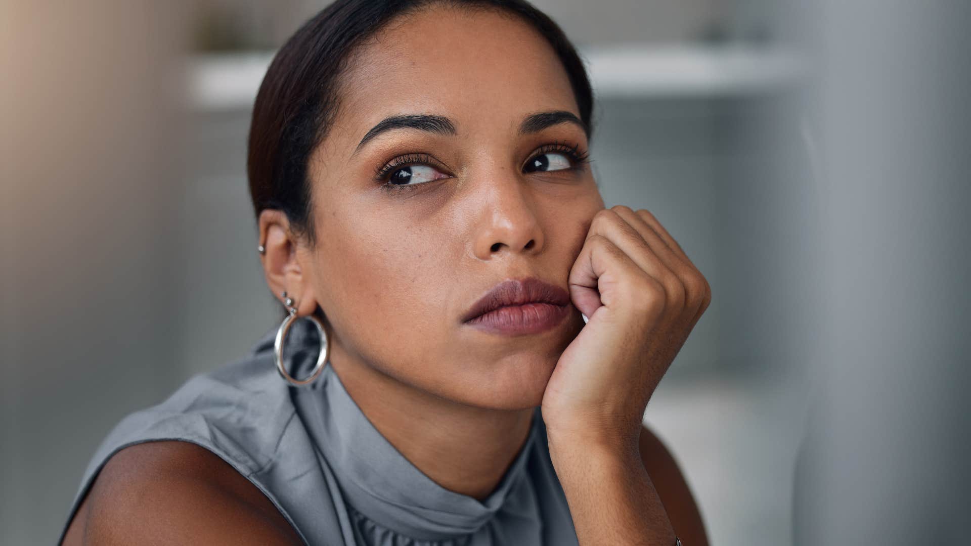 Woman saying "life isn't fair" at home.