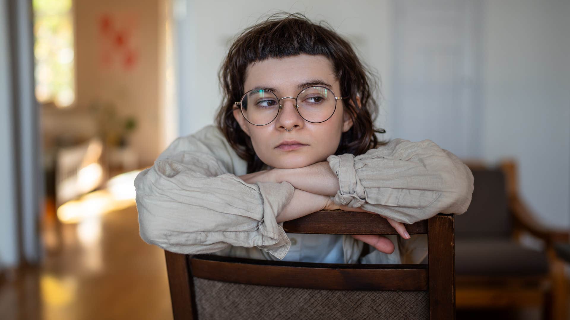 Woman saying "I stopped caring a long time ago" at home.