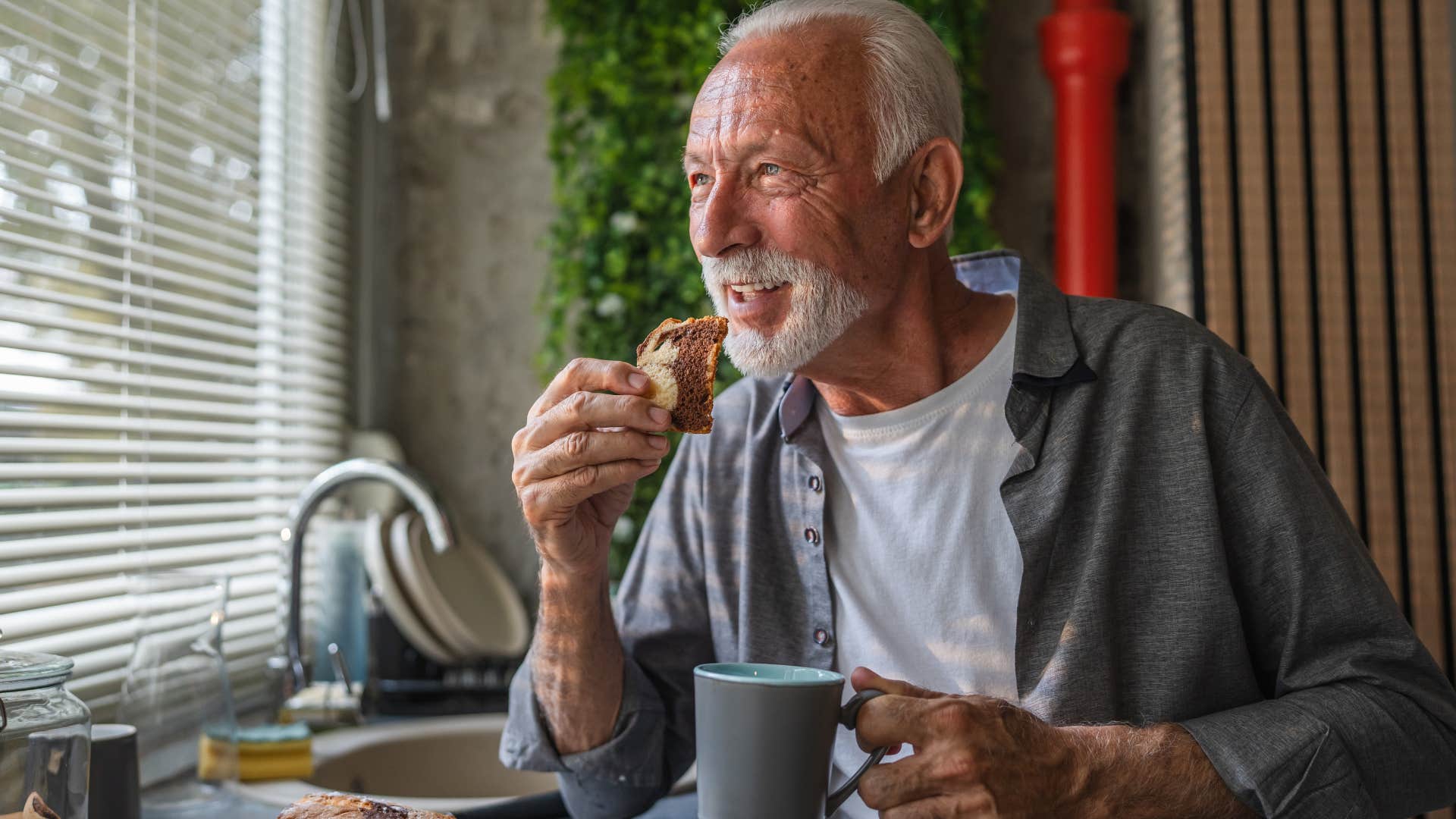 older man who craves simplicity drinking coffee at home