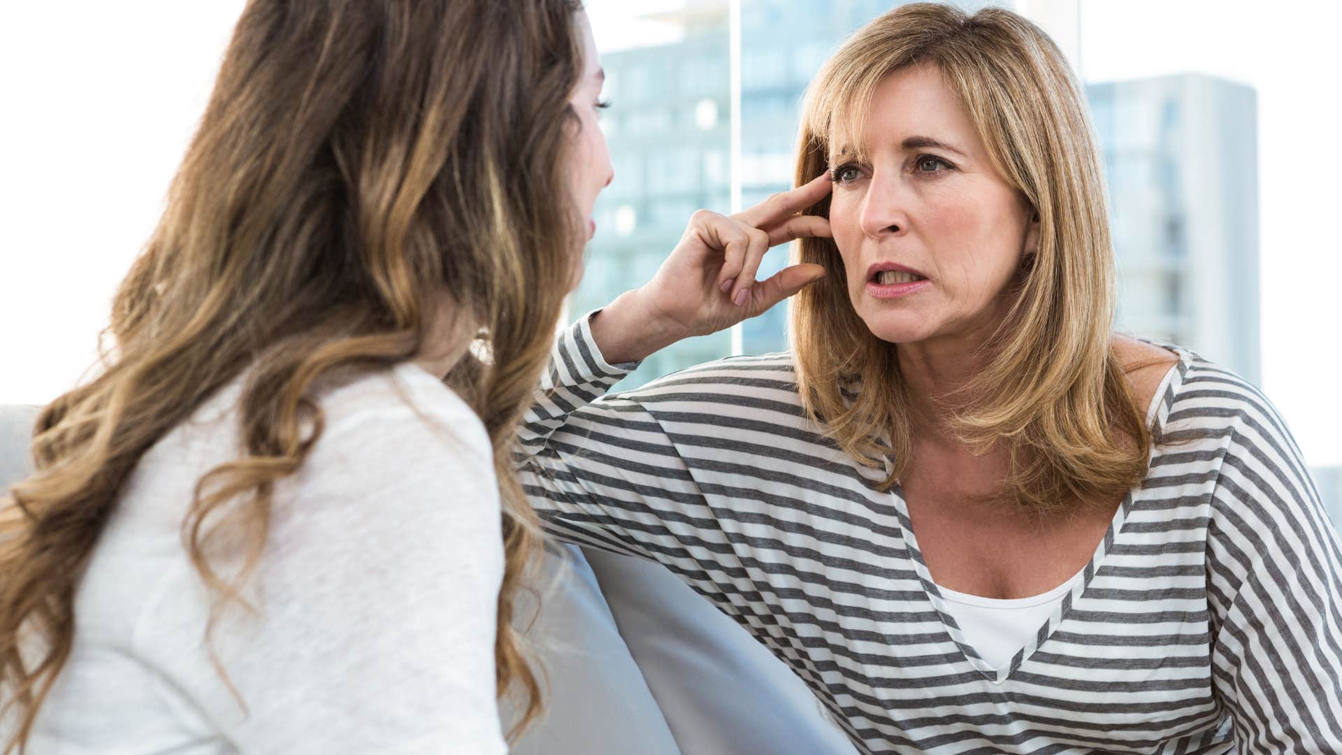 Serious woman saying "it's not a big deal" to her daughter.